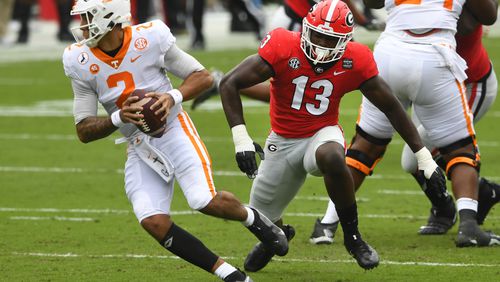 Georgia linebacker Azeez Ojulari (13) chases Tennessee quarterback Jarrett Guarantano (2) during the first half of a football game Saturday, Oct. 10, 2020, at Sanford Stadium in Athens. JOHN AMIS FOR THE ATLANTA JOURNAL- CONSTITUTION