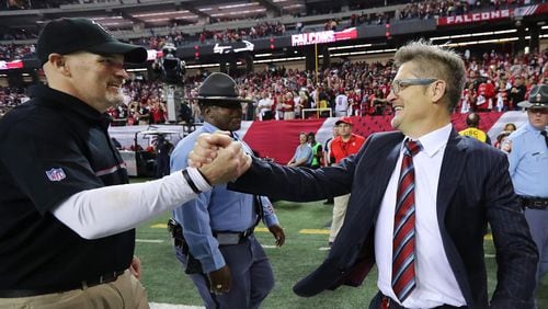 Falcons head coach Dan Quinn (left) and General Manager Thomas Dimitroff will be able to add one more player in the April 26-28 NFL draft.     Curtis Compton/ccompton@ajc.com