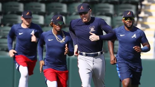 Braves Austin Riley (from left), Ronald Acuna, Freddie Freeman and Marcell Ozuna run sprints around the bases Sunday, Feb. 16, 2020, at CoolToday Park in North Port, Fla.