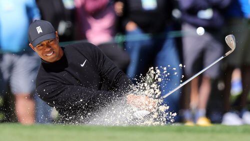 Tiger Woods, who found himself in a number hazards in his first Masters round since 2015, hits out of the  bunker on the second hole at Augusta National Thursday. Woods shot a 1-over-73 in the first round.