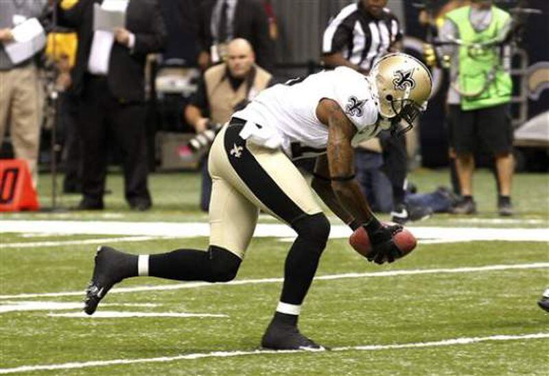 Saints special-teams player Courtney Roby picks up a blocked punt and runs it in for a touchdown during the 2012 season opener against the Redskins in the Mercedes-Benz Superdome. (Associated Press file photo by BILL HABER)