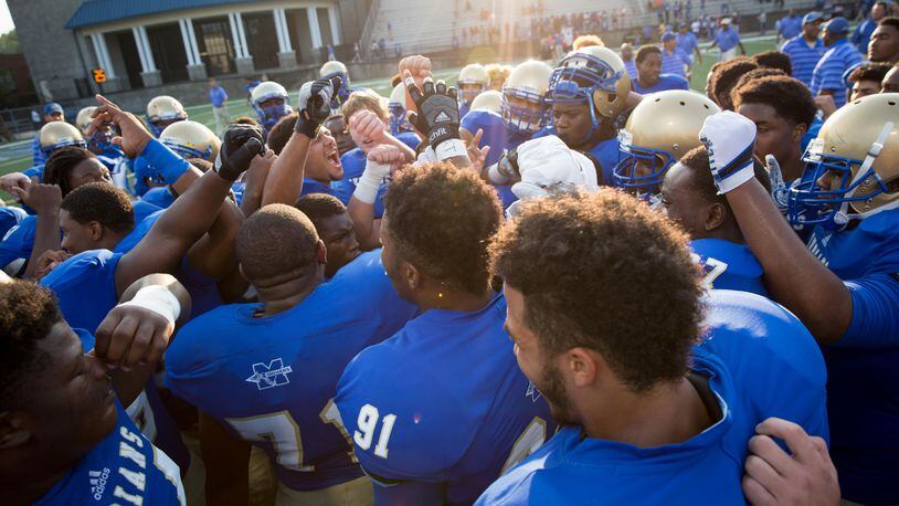McEachern huddles during warmups prior to the game against Buford at Walter H. Cantrell Stadium in Powder Springs, Ga. on Friday, Sept. 4, 2015. (Kevin Liles/AJC)