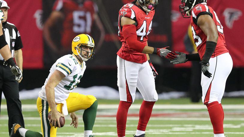 Falcons edge rusher Vic Beasley Jr. celebrates sacking Green Bay quarterback Aaron Rodgers with Dwight Freeney in the first half of a game Oct. 30. Beasley led the NFL with 15.5 sacks during the regular season. (Curtis Compton/ccompton@ajc.com)