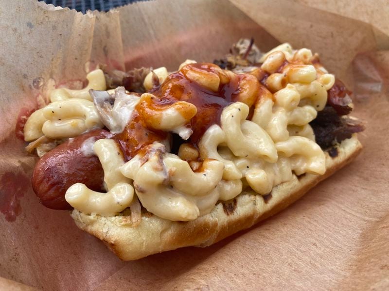 The Mac Daddy dog at DBA Barbecue is loaded with pulled pork, mac and cheese and a sweet, house-made barbecue sauce. Ligaya Figueras/ligaya.figueras@ajc.com
