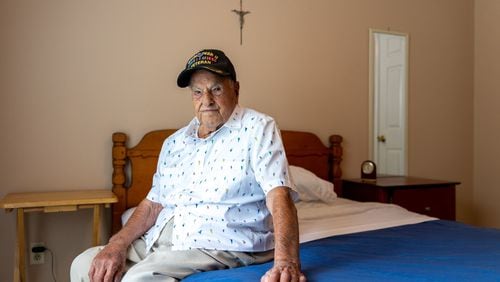 World War II veteran Eugene Russo, who turns 100 this month, at his home in Lawrenceville. (Arvin Temkar / AJC)