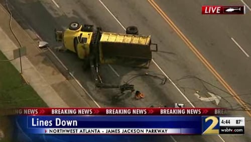 This yellow truck appears to have hit and downed power lines at Bolton Road and James Jackson Parkway on Thursday afternoon, authorities said.