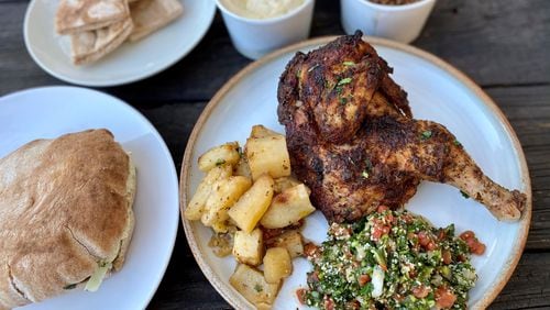 Takeout from Aviva by Kameel in Midtown: Rosemary chicken with roasted potatoes and tabouleh. Left, a pita pocket with falafel and all the fixings (hummus, baba ghanoush, cabbage salad, Nazareth salad). In the back: Pita, baba ghanoush and mujadara.
Wendell Brock for The Atlanta Journal-Constitution