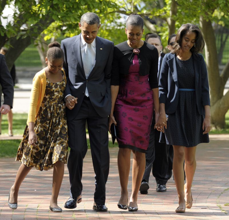 FILE - In this April 8, 2012, file photo, President Barack Obama, first lady Michelle Obama, daughters Malia, right, and Sasha walk across the square from the White House to St. John's Episcopal Church for Easter service in Washington. Michelle Obama has a new look, both in person and online, and with the president's re-election, she has four more years as first lady, too. The first lady is trying to figure out what comes next for this self-described "mom in chief" who also is a champion of healthier eating, an advocate for military families, a fitness buff and the best-selling author of a book about her White House garden. For certain, she'll press ahead with her well-publicized efforts to reduce childhood obesity and rally the country around its service members. (AP Photo/Susan Walsh, File) In this 2012 photo, President Barack Obama, first lady Michelle Obama, daughters Malia, right, and Sasha walk across the square from the White House to St. John's Episcopal Church for Easter service in Washington. (AP Photo)