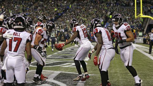 Atlanta Falcons' Mohamed Sanu (12) leads teammates in dancing in the end zone after scoring a touchdown against the Seattle Seahawks in the first half of an NFL football game, Monday, Nov. 20, 2017, in Seattle. (AP Photo/Stephen Brashear)