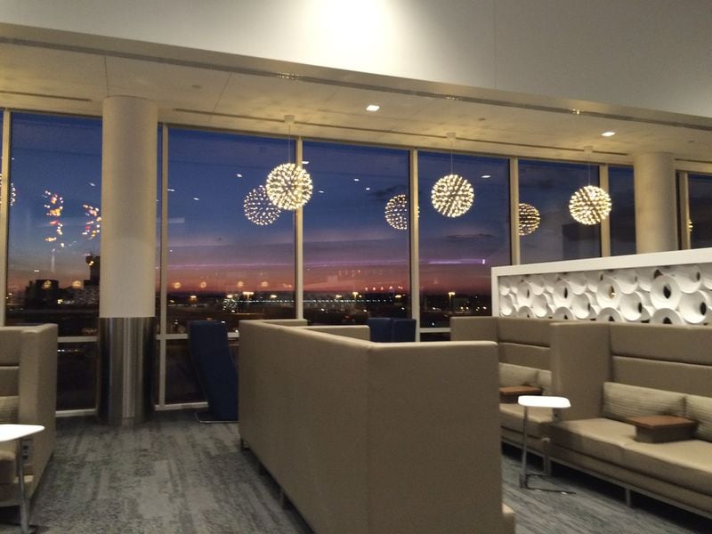 The new Delta Sky Club on Concourse B is bigger and fancier and offers views of aircraft operations and the city skyline beyond. KELLY YAMANOUCHI/kyamanouchi@ajc.com