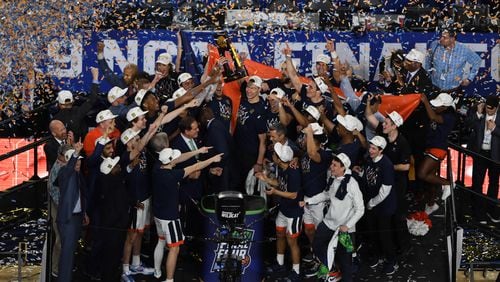 Virginia  players celebrate with the trophy after defeating Texas Tech  in the national championship game.