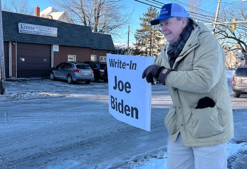 Bob Mulholland waving a “write-in Joe Biden” sign on Hooksett Road in Manchester, New Hampshire. (Patricia Murphy/patricia.murphy@ajc.com)