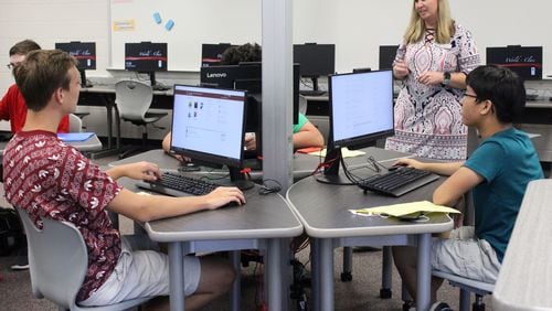 8/5/18 - Norcross - Beckie Mae, a teacher at Paul Duke STEM High School, helps her students login to their computers in an AP computer science class during their first day at school on Monday, August 6. Jenna Eason / Jenna.Eason@coxinc.com