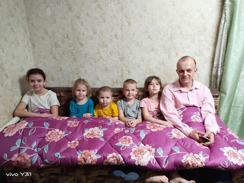Pictured is a Ukrainian family under a blanket donated through HelpingUkraine.US. Courtesy HelpingUkraine.US