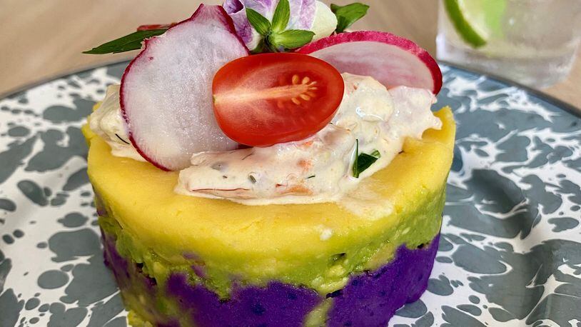 At a recent pop-up dinner at Silver Queen restaurant in Monroe,  La Chingana chef Arnaldo Castillo served this Peruvian causa, layered with purple potato, avocado, white potato and shrimp salad.
Wendell Brock for The Atlanta Journal-Constitution