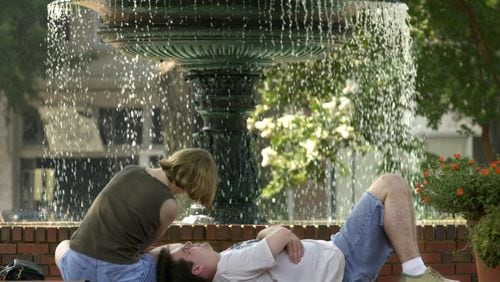 July 3, 2000: Valerie Stockett and Matt Riedel both from Baltimore, Maryland, enjoying a restful morning interlude near the popular fountain on the Marietta Square. They were in town for the holiday visiting Stockett's parents.