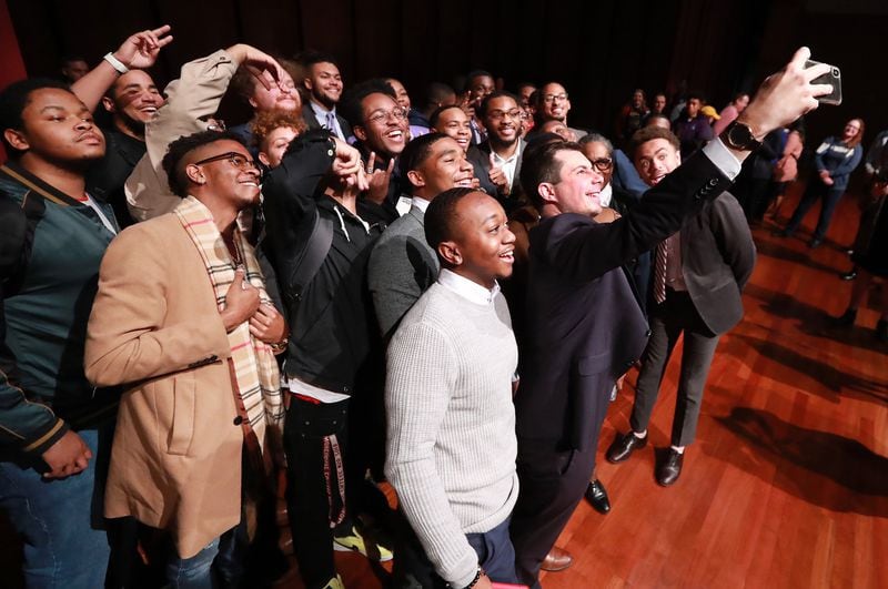 Presidential hopeful Pete Buttigieg, mayor of South Bend, Indiana, snaps a selfie with students after speaking while launching a new effort to win over black voters during a conversation at Morehouse College on Monday, November 18, 2019, in Atlanta. CURTIS COMPTON/AJC