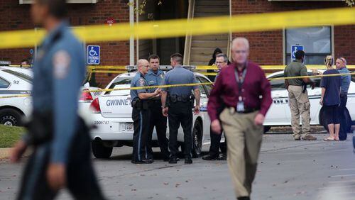 Gwinnett County police and the Georgia Bureau of Investigations work at the scene of an officer-involved shooting at the Sugar Mill Apartments near Lawrenceville on Wednesday afternoon, Oct. 28, 2015. Police say they were called to a domestic disturbance when an officer was confronted by a knife-wielding suspect, who the officer shot. (Ben Gray / bgray@ajc.com)