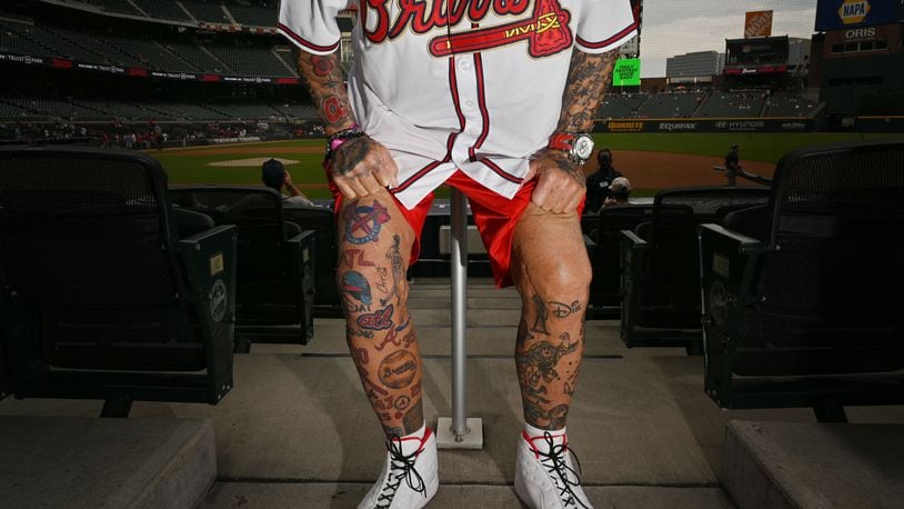 Steve Disney shows off his Braves tattoos before the Atlanta Braves home game against the St. Louis Cardinals at Truist Park on Sept. 6. (Hyosub Shin / Hyosub.Shin@ajc.com)
