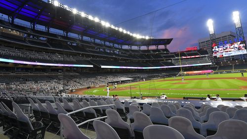 Cardboard cutouts of fans in the otherwise empty seats face the field at the Braves' Truist Park for a game against the Tampa Bay Rays, Thursday, July 30, 2020 in Atlanta.