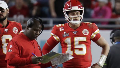 Offensive coordinator Eric Bieniemy speaks with Kansas City Chiefs quarterback Patrick Mahomes (15) during the second half of Super Bowl 54 against the San Francisco 49ers, Sunday, Feb. 2, 2020, in Miami Gardens, Fla. (Lynne Sladky/AP)
