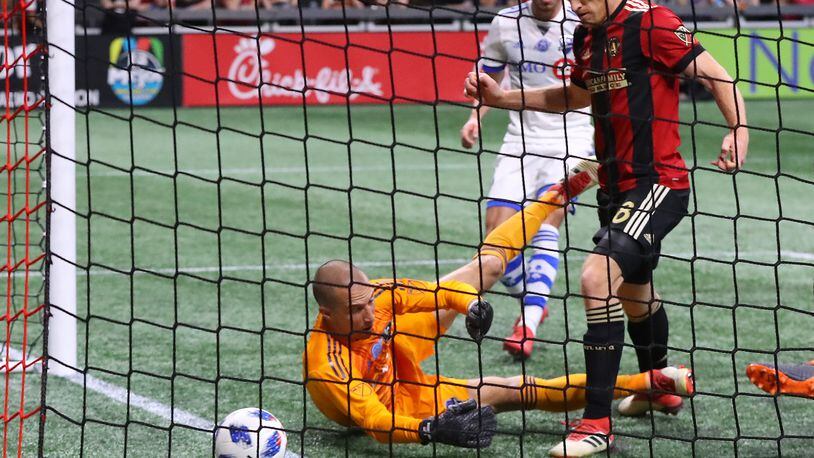 April 28, 2018 Atlanta: Atlanta United midfielder Jeff Larentowicz scores an apparent goal past Montreal Impact goalkeeper Evan Bush but the United were ruled offsides on the play during the first half in a MLS soccer game on Saturday, April 28, 2018, in Atlanta.  Curtis Compton/ccompton@ajc.com