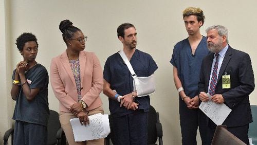 Attorney Don Samuel (right) with his client Jacob Wilson as (from left) Andrew Monden, Vincent Castillenti's attorney, Fallon Stokes, and Vincent Castillenti stand during a bond hearing at Fulton County jail on Wednesday, September 20, 2017. The three suspects arrested during a protest on the Georgia Tech campus were granted bond ranging from $20,000 to $107,500.