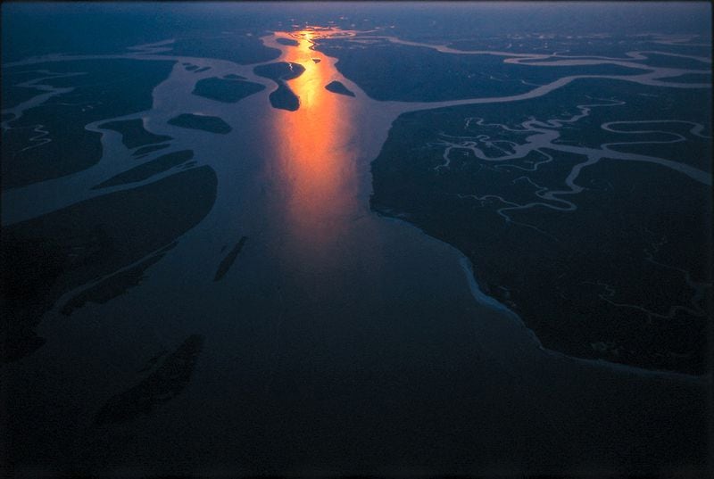 A flare of dying light blazes a trail through intricacies of salt marsh near the mouth of the Altamaha River. 