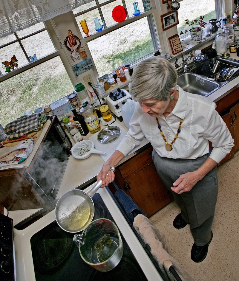 Edith Edwards, nicknamed "the Kudzu Queen of North Carolina," pours boiling water over some crushed dried Kudzu leaves to make tea inside her home near Harris, N.C., March 14, 2007.