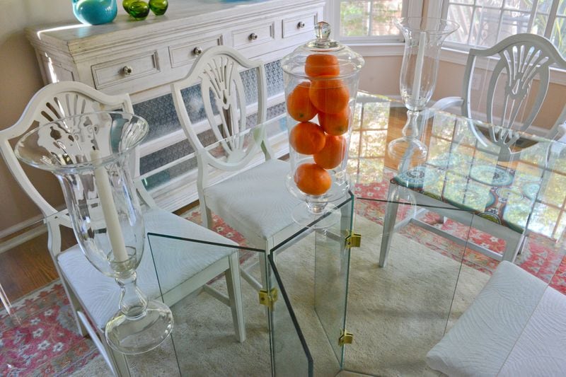 It's glass on glass, anchored with white chairs and a white buffet, for the dining room tabletop and decor in the Vining townhome. Text by Lori Johnston and Keith Still/Fast Copy News Service. (Christopher Oquendo Photography/www.ophotography.com)