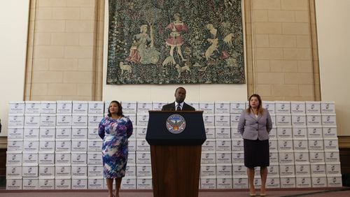 Atlanta Mayor Kasim Reed, standing in front of boxes of documents related to the City Hall bribery investigation during a February press conference. The city has used an outside law firm for the past year to help it identify and prepare documents for the public, and the U.S. Attorney’s Office.