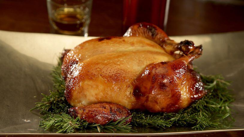 Distilled liquors such as bourbon can enhance the flavor of food, like this honey-bourbon roast chicken. (Kirk McKoy/Los Angeles Times/TNS)
