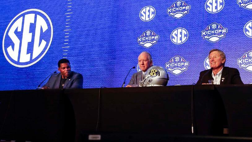 Herschel Walker, left, Archie Manning, center, and Steve Spurrier talk about 150 years of college football during the NCAA college football Southeastern Conference Media Days, Tuesday, July 16, 2019, in Hoover, Ala. (AP Photo/Butch Dill)