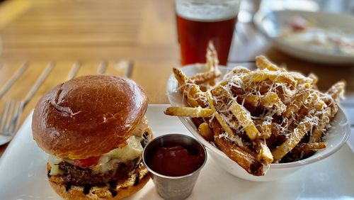 Seed Kitchen & Bar serves a terrific burger; shown here with Parmesan fries. (Wendell Brock for The Atlanta Journal-Constitution)