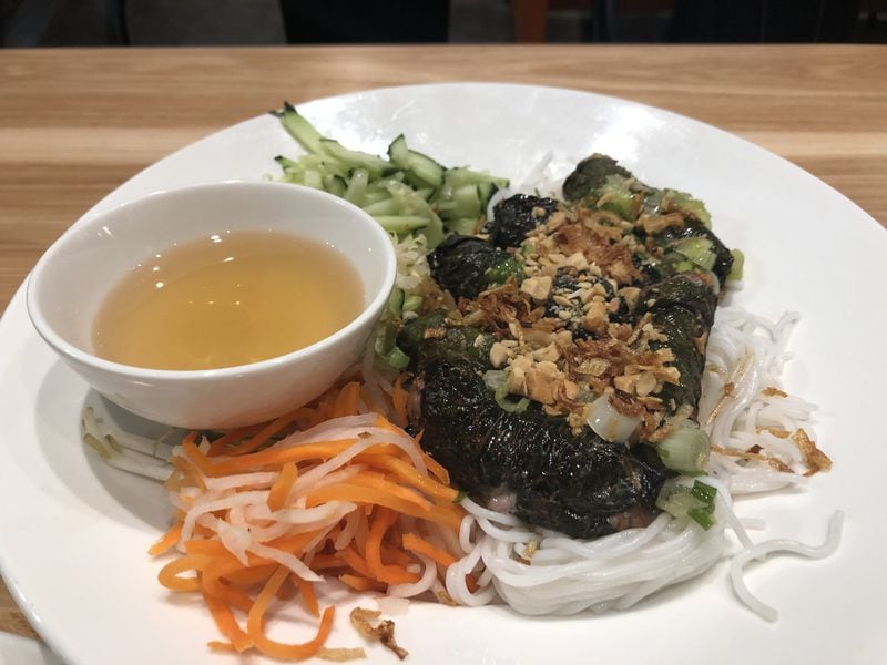 The “bo la lot” — a sausage-like blend of beef and pork rolled cigar style in betel leaves, then grilled to a char — at Vietvana in Avondale Estates. CONTRIBUTED BY WENDELL BROCK