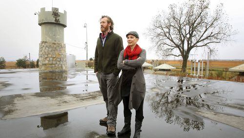 In this Nov. 2, 2017 photo, Mathew Fulkerson and his wife Leigh Ann stand on top of the bunker that once housed an intercontinental ballistic missile at their Subterra Airbnb located in a former underground missile silo base near Eskridge, Kan. The Subterra Castle Airbnb opened for business about six months ago. (Thad Allton/The Topeka Capital-Journal via AP)