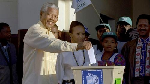 FILE - Then African National Congress leader, Nelson Mandela casts his vote April 27, 1994 near Durban, South Africa, in the country's first all-race elections. South Africans celebrate "Freedom Day" every April 27, when they remember their country's pivotal first democratic elections in 1994 that announced the official end of the racial segregation and oppression of apartheid. (AP Photo/John Parkin. File)