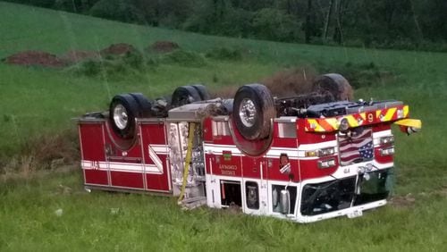 Four Forsyth County firefighters were injured Friday morning while responding to calls during severe storms, authorities said. Their truck overturned on their way to the blaze.