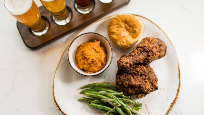 Southern fried chicken with molasses biscuit, braised green beans, and sweet potato mash and a local beer flight at Chicken + Beer. / Photo credit- Mia Yakel.