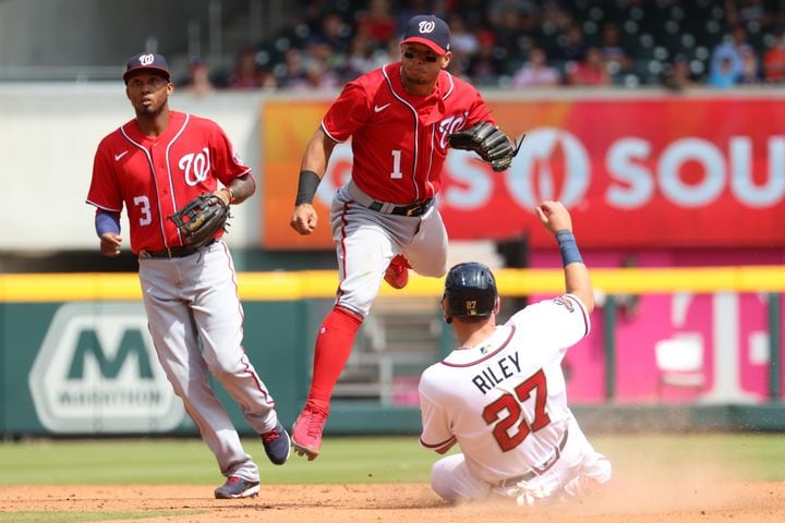 Nationals second baseman Cesar Hernandez throws to first to complete a double play in the ninth inning. The visiting Nationals won the series 2-1. (Miguel Martinez/miguel.martinezjimenez@ajc.com)