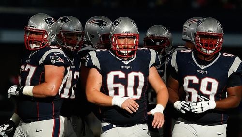 Patriots center David Andrews (60) and guard Shaq Mason (69) are side by side, ready in this case for a second half against Dallas last season. (Christian Petersen/Getty Images)