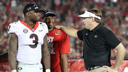 Georgia coach Kirby Smart stands on stage with Roquan Smith and Nick Chubb after beating Oklahoma 54-48 during double over time in the College Football Playoff Semifinal at the Rose Bowl Game on Monday, January 1, 2018, in Pasadena.    Curtis Compton/ccompton@ajc.com