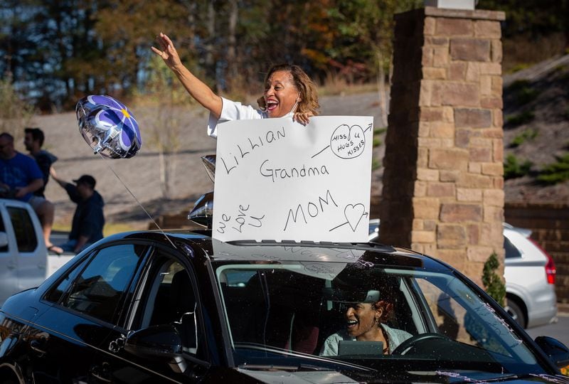 Camilla White waves to her mother, Lillian Barber, as she drives by during the Thanksgiving Day outdoor parade at the assisted living home Oaks at Douglasville on Thursday, November 26, 2020.  (Photo: Steve Schaefer for The Atlanta Journal-Constitution)