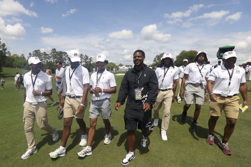 Morehouse College men’s golf team walks with Earl Cooper, center, of Eastside Golf, as they walk down the 18th fairway during the practice round of the 2024 Masters Tournament at Augusta National Golf Club, Wednesday, April 10, 2024, in Augusta, Ga. (Jason Getz / jason.getz@ajc.com)