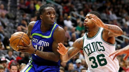 Atlanta Hawks forward Taurean Prince (12) looks to pass as Boston Celtics guard Marcus Smart (36) defends in the second half of an NBA basketball game on Thursday, April 6, 2017, in Atlanta. The Hawks won the game 123-116. (AP Photo/Todd Kirkland)