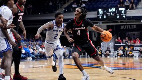 Georgia guard Silas Demary Jr. (4) drives past Seton Hall guard Al-Amir Dawes (2) in the first half of an NCAA college basketball game in the semifinals of the NIT, Tuesday, April 2, 2024, in Indianapolis. (AP Photo/Michael Conroy)
