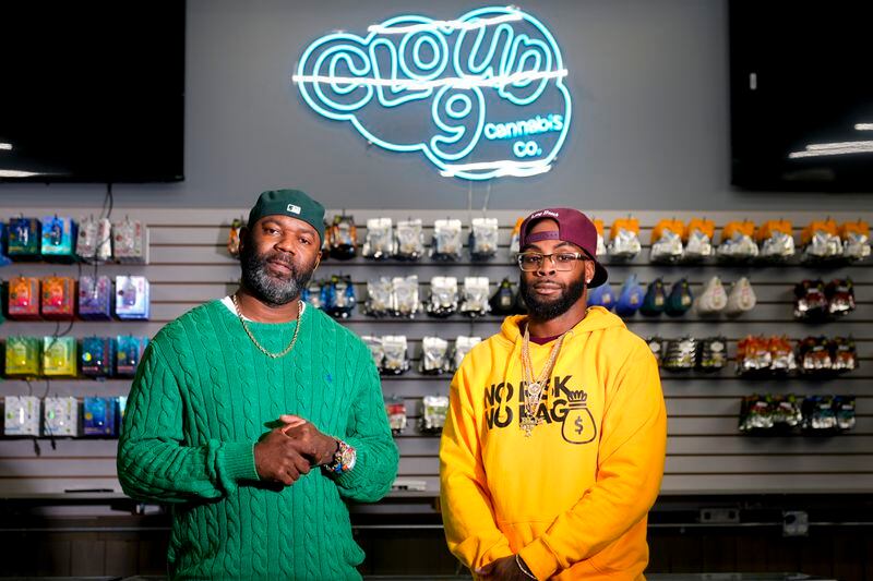 Cloud 9 Cannabis co-owner Dennis Turner, left, poses for a portrait with CEO and co-owner Sam Ward Jr., at their shop, Thursday, Feb. 1, 2024, in Arlington, Wash. Cloud 9 is one of the first dispensaries to open under the Washington Liquor and Cannabis Board's social equity program, established in efforts to remedy some of the disproportionate effects marijuana prohibition had on communities of color. (AP Photo/Lindsey Wasson)