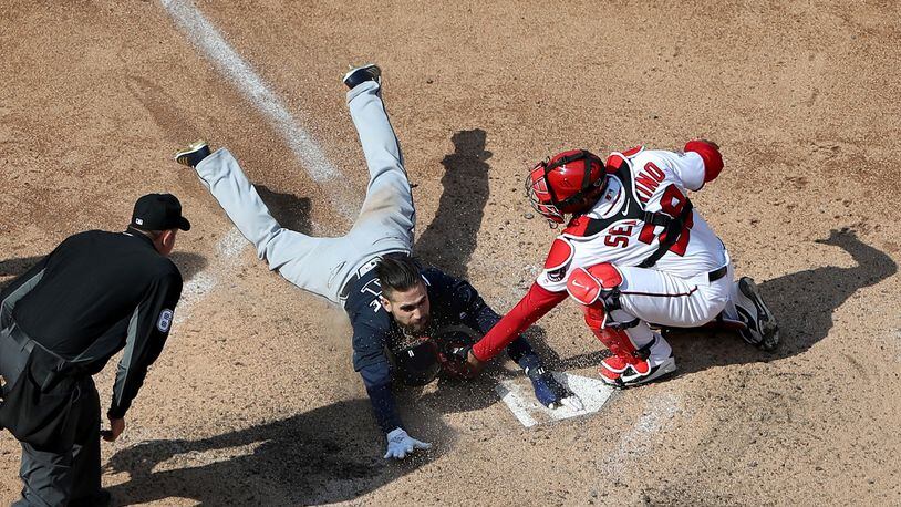 The Braves’ Ender Inciarte is tagged by Nationals catcher Pedro Severino for the third out of the 10th inning when Inciarte tried to steal home. (Photo by Rob Carr/Getty Images)
