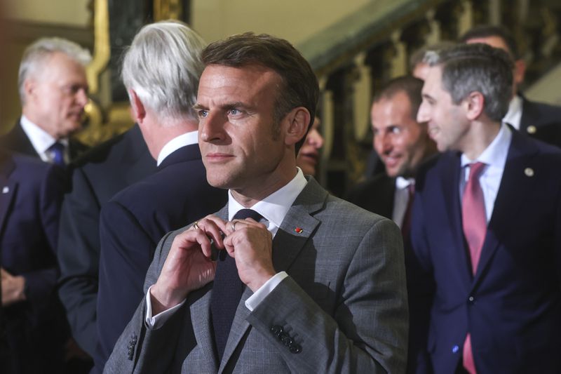 French President Emmanuel Macron, center, prior to a group photo during a reception at the Royal Palace prior to an EU summit in Brussels, Wednesday, April 17, 2024. (Olivier Hoslet, Pool Photo via AP)