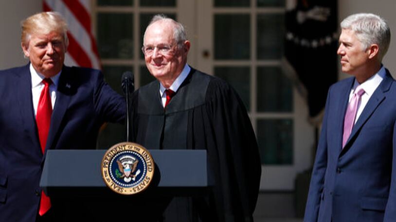 President Donald Trump, left, Supreme Court Justice Anthony Kennedy, center, and Justice Neil Gorsuch participate in a public swearing-in ceremony for Gorsuch in the Rose Garden of the White House White House in Washington, Monday, April 10, 2017. (AP Photo/Carolyn Kaster)